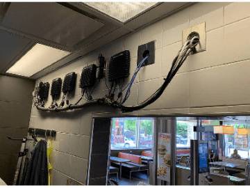 A wall with multiple electrical wires attached, indicating a complex network of electrical connections
